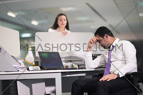 frustrated young business man working on desktop  computer at modern office