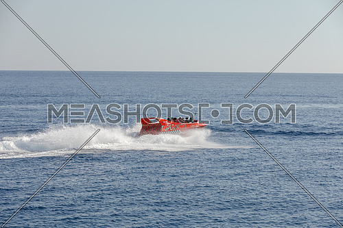 Long shot for speed-boat sailing fast in The Red Sea by day.