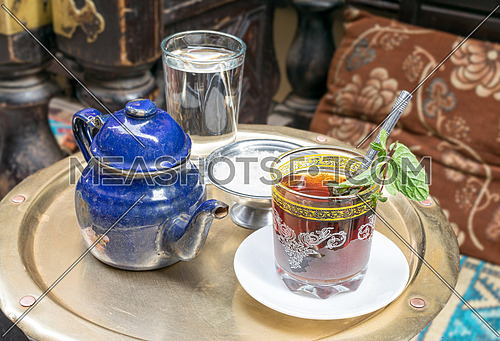 Traditional mint tea set on copper table in an oriental cafe at Khan El Kalili Bazar, Cairo, Egypt