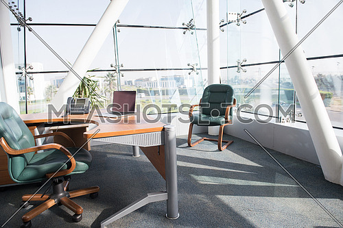 empty modern office with laptop computer on table