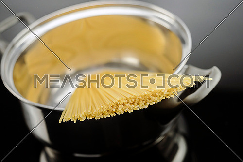 Spaghetti inside a pot, conceptual image