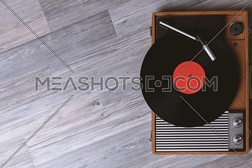 Turntable vinyl record player on the background of their gray wooden boards. Needle on a vinyl record. Black vinyl record,Sound technology for DJ to mix & play music.