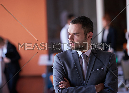 happy young business man portrait  at modern meeting office indoors