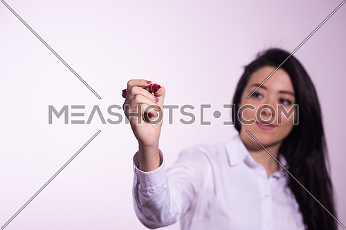 Middle eastern  business woman writing with marker on virtual screen isolated on white background