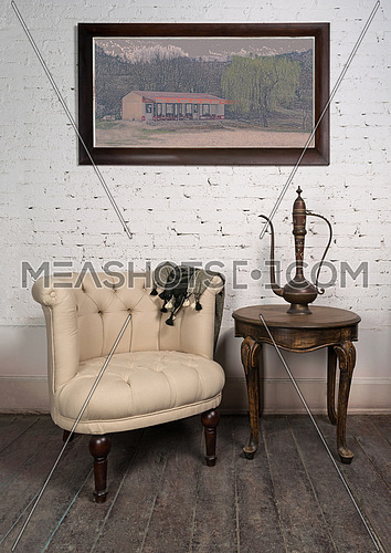 Old beige armchair,  brass teapot, framed painting and antique t