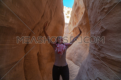Female Tourist walking inside through the white canyon Mountain in Sinai Trail at day