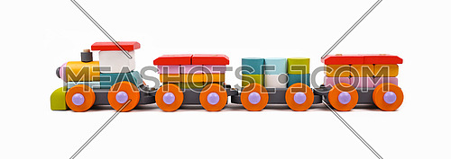 Close up one wooden painted colorful toy train isolated on white background, low angle, side view