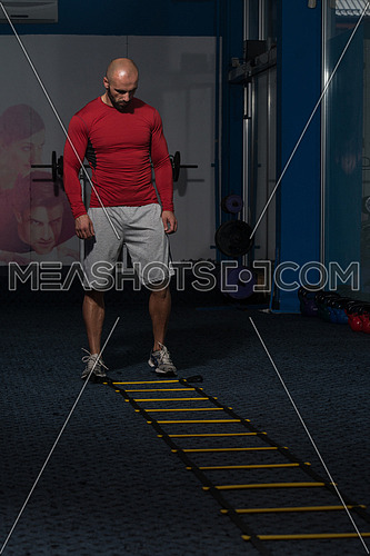Handsome Man Running On Step Ladders Lying On Floor - Sports And Fitness - Concept Of Healthy Lifestyle - Fitness Male