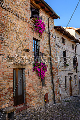 Beautiful vintage balcony with colorful flowers and stone wall medieval , Mediterranean style