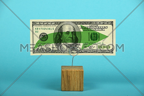 Stagnation and support of American economy and US dollar, one dollar banknote with green horizontal arrow on holder over blue background