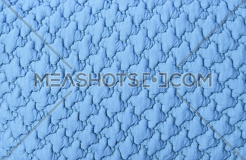 Close up background texture of pastel blue soft tufted textile upholstery pattern