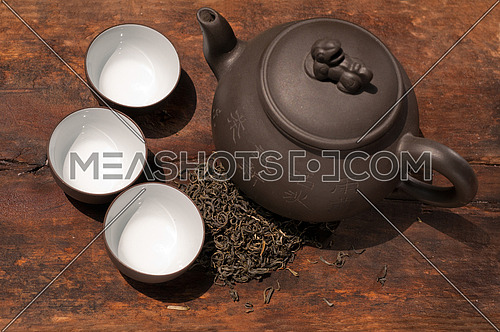 chinese green tea traditional  pot and cups over old wood board