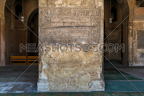 Ornate engraved stone wall with ruined floral patterns at Ahmed Ibn Tulun Mosque, Cairo, Egypt