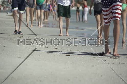 people walking on a busy beach