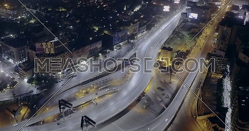 Aerial shot flying around 6 of October Bridge over Abd Elmonan Reyad Bus Station At Tahrir Area in cairo at night