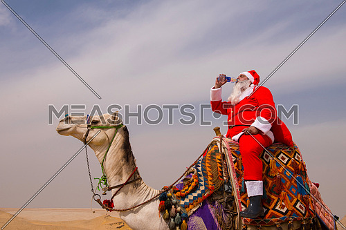 santa claus riding a camel in pyramids desert in Egypt Christmas concept