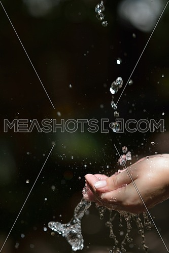 beauty and spa fresh water stream on woman hand