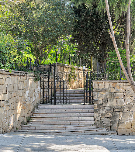 Ascending marble stairs leading to a public park, Stone wall, and fence iron door, Buyukada Island, Istanbul, Turkey