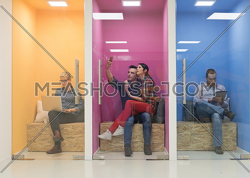 group of young business people having fun, relaxing and working in creative room space at modern startup office