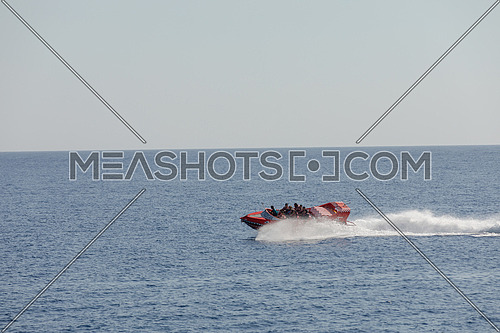 Long shot for speed-boat sailing fast in The Red Sea by day.