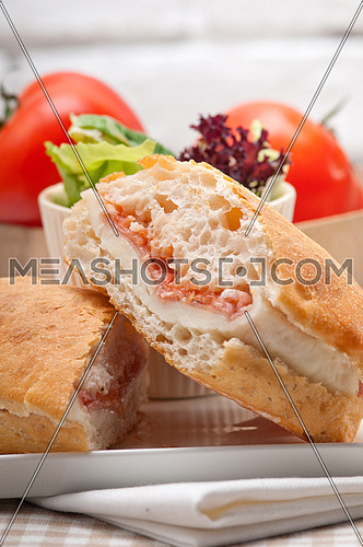 Italian ciabatta panini sandwich with parma ham and tomato