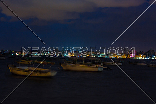 shot for sea shore showing fishing boats at alexandria from day to night
