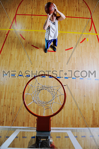 basketball game playeer shooting on basket indoor in gym