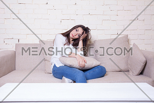 A gril sitting on a couch