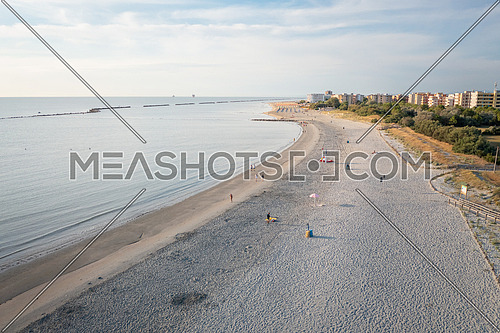 Aerial view of sandy beach and town background.Summer vacation concept.Lido Adriano town,Adriatic coast, Emilia Romagna,Italy.