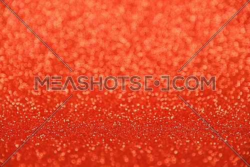 Abstract background of red bokeh defocused blurred lights and glitter sparkles