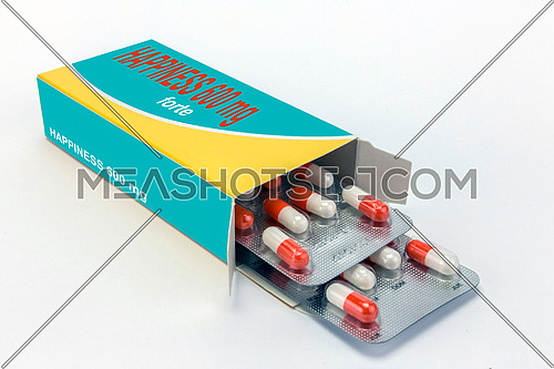 Open medicine packet labelled happiness opened at one end to display a blister pack of tablets, isolated on white