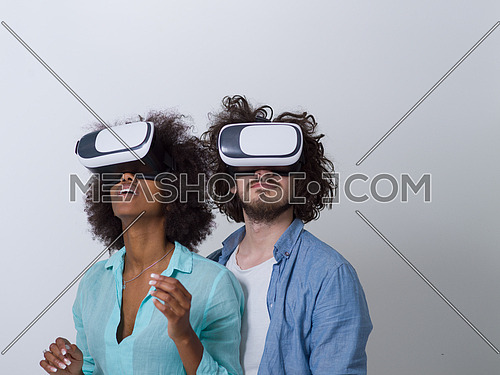 Happy multiethnic couple getting experience using VR headset glasses of virtual reality, isolated on white background