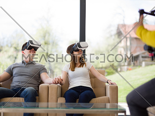 Couple using virtual reality headset in living room at home  people playing game with new trends technology