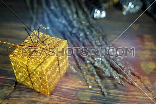 Festive Christmas background with golden gift and assorted decorations