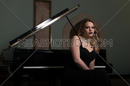 Young Artist in Black Velvet Evening Dress Playing at the Old Wooden Piano Classical Sonata by Gentle Candlelight