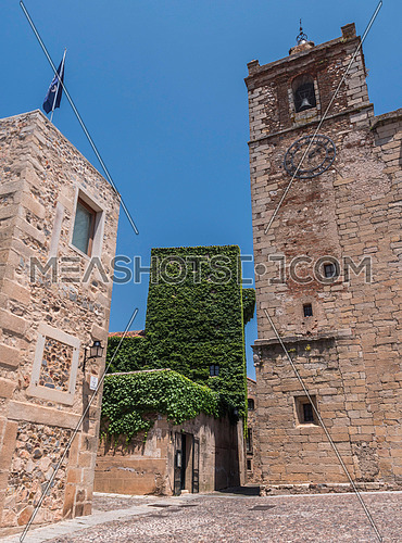 Caceres, Spain - july 13, 2018: Church of San Mateo and Torre de Sande, is Gothic, from the 14th century, rebuilt in the 15th century, located in the square of San Mateo, Caceres, Spain