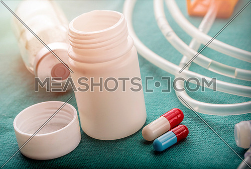 Vial and boat of medicines in a table of a hospital, conceptual image