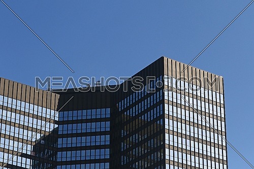 Office building or corporate headquarter tower against blue skies