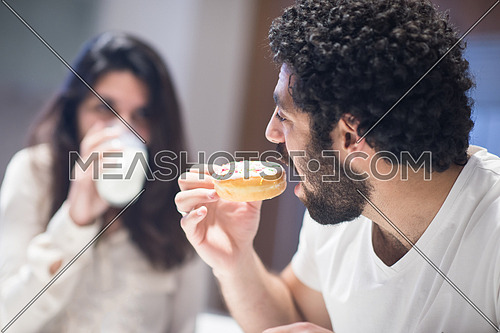 Young middle east couple eating a meal and happily spends time in the kitchen
