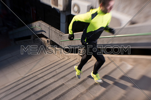 man jogging  at cold autumn  mornigng on steps