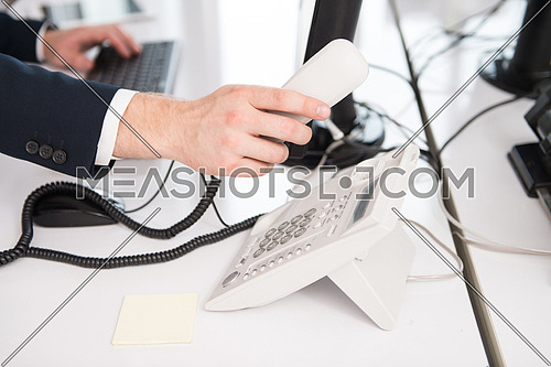 Businessman Pick Up Or Hangs Up The Phone In The Office