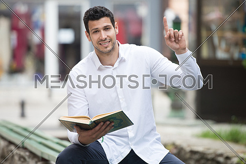 Humble Muslim Man Is Reading The Koran Outdoors