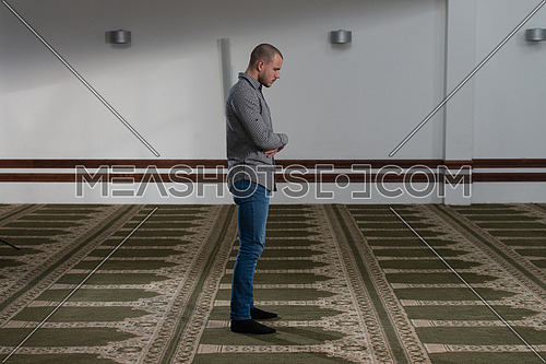 Young Muslim Man Making Traditional Prayer To God Allah