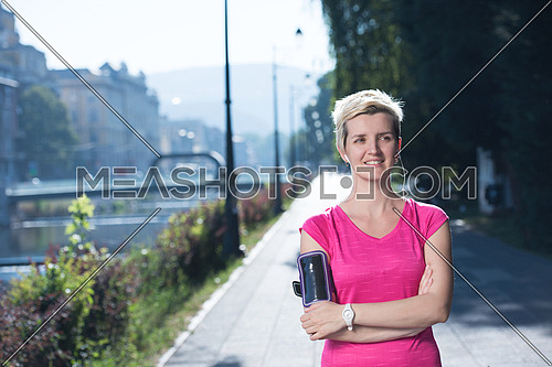 portrait of jogging woman before running  on early morning with sunrise in background