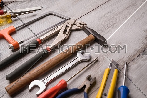 Screwdriver,hammer,tape measure and other tool for construction tools on gray wooden background,industry engineer tool concept.still-life.