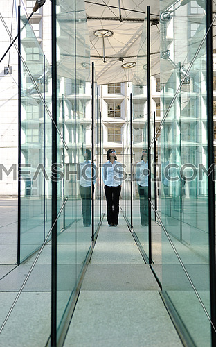 beautiful young woman standing in a modern glass interior building