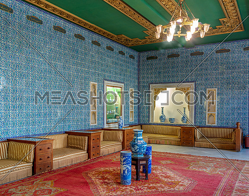 Manial Palace of Prince Mohammed Ali. Blue tiled hall at the residence of the prince's mother with Turkish floral blue pattern ceramic tiles and niches with porcelain vases, Cairo, Egypt