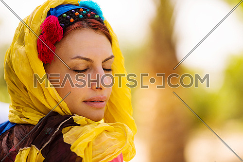 portrait of a young beautiful middle eastern woman with a smile on her face on a sunny summer day