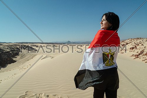 Female tourists spreading Egyptian flag while exploring Sinai Trail from Ain Hodouda at day.
