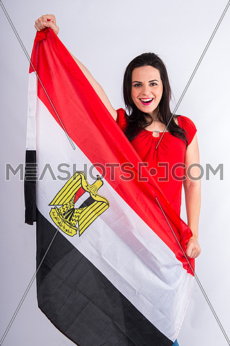 A beautiful young woman encourages the Egyptian football team, holding the flag of Egypt